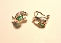 Lot 1068 - A pair of white and yellow gold emerald earrings