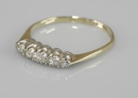 Lot 1040 - A five stone graduated diamond ring
