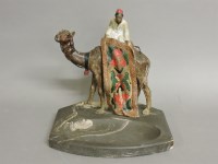 Lot 1186 - An Austrian cold painted spelter figure of a carpet seller on a camel
