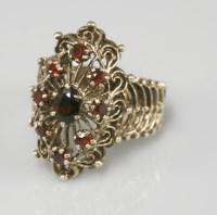 Lot 1028 - A marquise shaped garnet cluster ring