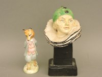 Lot 1231 - A pottery bust of a figure of a female clown