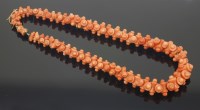 Lot 315 - A Victorian salmon pink carved coral necklace