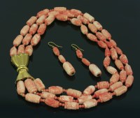 Lot 498 - A Continental three row graduated carved coral bead necklace and earring suite