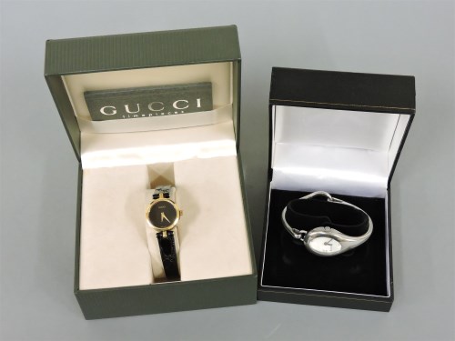 Lot 13 - A ladies' stainless steel Gucci 103 bangle watch