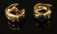 Lot 555 - A pair of 18ct gold sapphire and diamond crossover hoop earrings