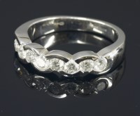 Lot 650 - An 18ct white gold diamond set half eternity ring