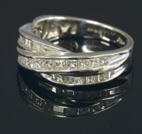 Lot 683 - An 18ct white gold diamond set crossover eternity ring