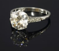 Lot 350 - A single stone diamond ring with diamond set shoulders