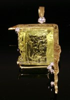 Lot 561 - A gold citrine and diamond pendant by Catherine Best