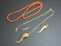 Lot 73 - Two gold horn pendants