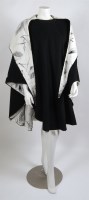 Lot 208 - A reversible black wool and ivory and black silk print lined hooded cape