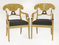 Lot 377 - A pair of Biedermeier-style maple and ebonised bar back elbow chairs