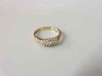 Lot 3 - A 9ct gold three row diamond cluster ring
