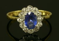 Lot 4 - An 18ct gold oval sapphire and diamond cluster ring