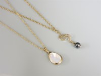 Lot 10 - A 9ct gold haematite bead pendant and chain