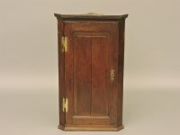 Lot 557 - A small 19th century oak hanging corner cabinet
