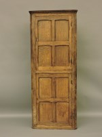 Lot 571 - An oak standing corner cabinet