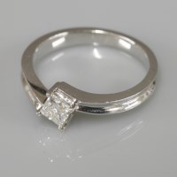 Lot 1017 - An 18ct white gold single stone princess cut diamond crossover ring
