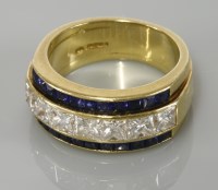 Lot 1 - An 18ct gold diamond and sapphire half hoop ring