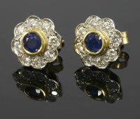 Lot 557 - A pair of 18ct gold sapphire and diamond circular cluster earrings