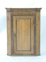 Lot 473 - A George III oak corner cupboard