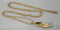 Lot 24 - A gold shoe pendant