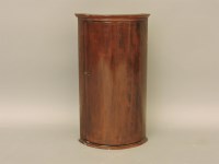 Lot 585 - A small Georgian style mahogany bow fronted hanging corner cupboard