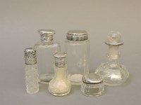 Lot 70 - Six silver topped glass scent bottles and jars