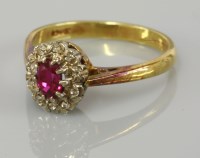 Lot 2 - A ruby and diamond oval cluster ring