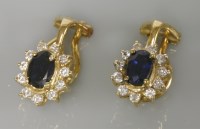 Lot 19 - A pair of 18ct gold sapphire and diamond oval cluster clip on earrings