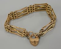 Lot 32 - An Edwardian gold four row gate bracelet