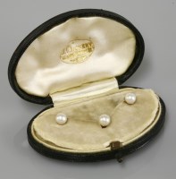 Lot 16 - A cased set of three pearl set gold dress studs