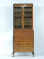 Lot 542 - A 20th century oak bureau bookcase