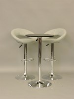 Lot 595 - A black top and chrome base circular drinks table