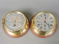 Lot 258 - A modern brass ship's clock and barometer