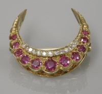 Lot 12 - A 9ct gold ruby and diamond crescent brooch