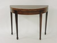 Lot 504 - A Georgian mahogany demi lune card table