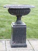 Lot 463 - A cast iron urn and stand