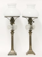 Lot 137 - A pair of Elkington & Co. silver-plated candlestick oil lamps