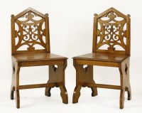 Lot 522 - A pair of Victorian oak hall chairs