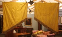 Lot 1154 - Two pairs of heavy canary yellow silk shaped drapes