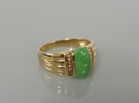 Lot 170 - A gold single stone jade ring