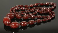 Lot 201 - A single row of graduated cherry coloured Bakelite olive shaped beads