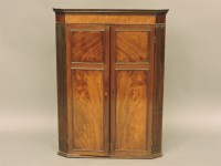 Lot 474 - A 19th century mahogany hanging corner cupboard