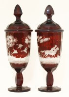 Lot 75 - A pair of Bohemian ruby glass Jars and Covers