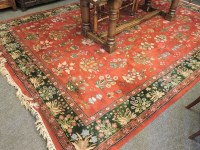 Lot 581 - A burgundy ground carpet