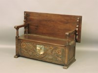 Lot 595 - An early 20th century stained oak monk's bench