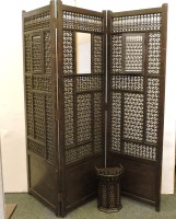 Lot 637 - A three fold stained Moroccan Mashrabiya panelled screen