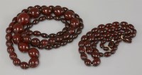 Lot 11 - Two rows of graduated olive shaped 'red cherry' bakelite bead necklaces
