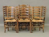 Lot 724 - A set of eight early 19th century style elm ladder back chairs